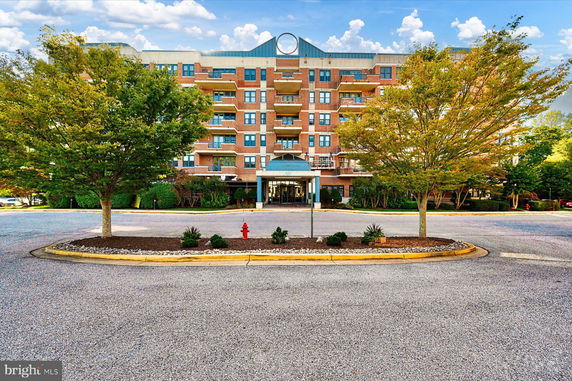 Front view of a multi-story brick apartment building.