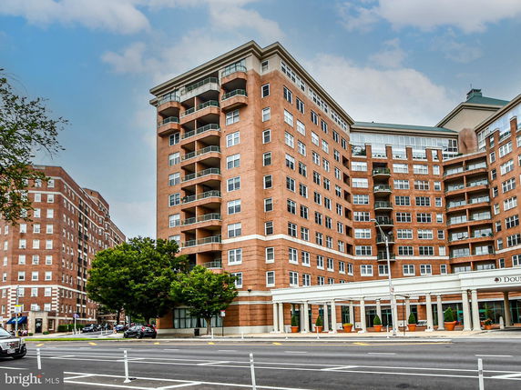 Front view of a multi-story residential building with balconies.