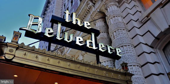 Front view of a building facade with decorative columns and a sign that reads 'The Belvedere'.