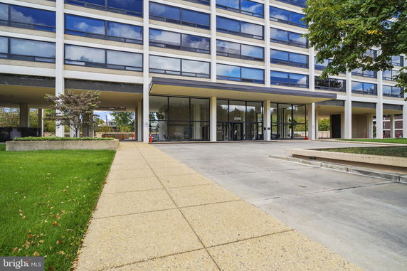 Front view of a multi-story commercial building with large windows.
