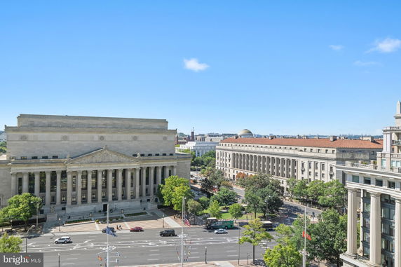 Panoramic view of historic buildings and streets in a city setting.