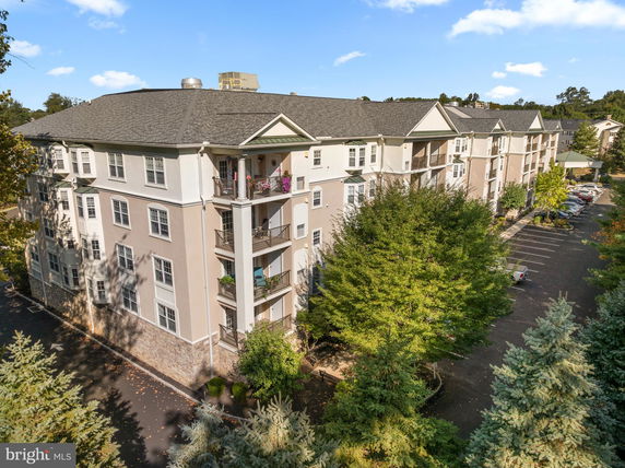 Front view of a multi-story apartment building with balconies.