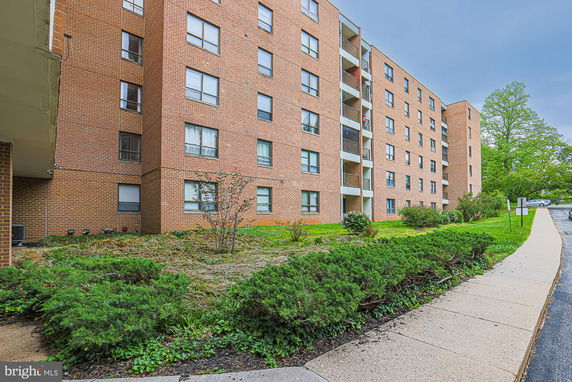 Front view of a multi-story brick apartment building.