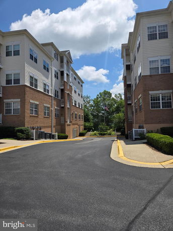 Front view of apartment buildings with brick and siding facade.