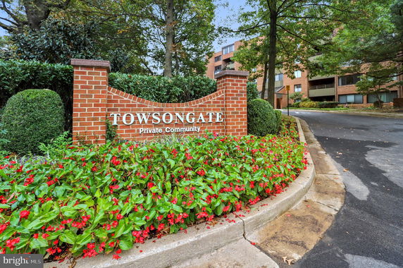 Entrance sign of a private community with a brick wall.