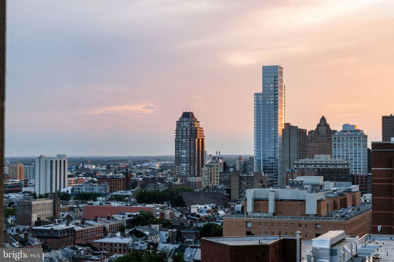 Panoramic view of city buildings at sunset.