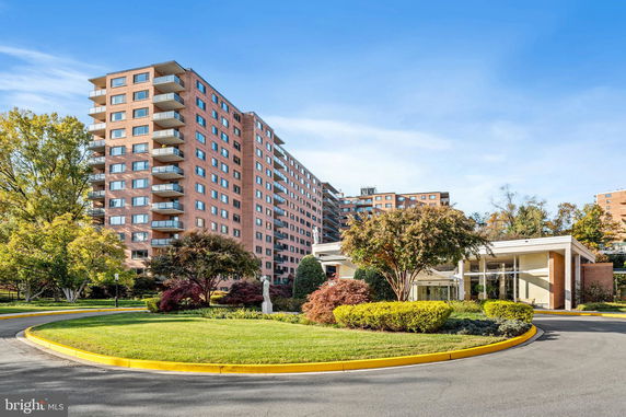 Front view of a multi-story apartment building with balconies.
