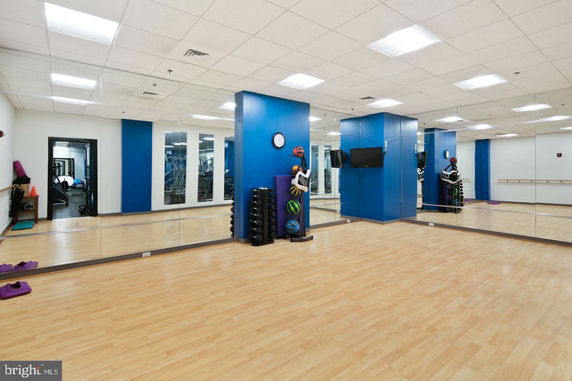 Indoor gym area with mirrors and gym equipment.