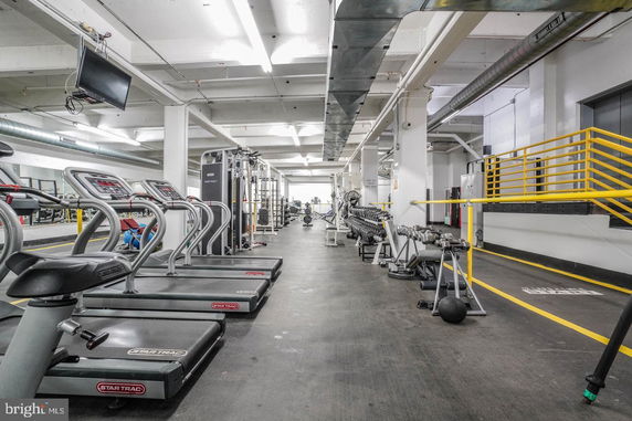 Interior view of a gym with exercise equipment and treadmills.