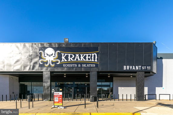 Front view of a building with signage for Kraken Kourts & Skates.
