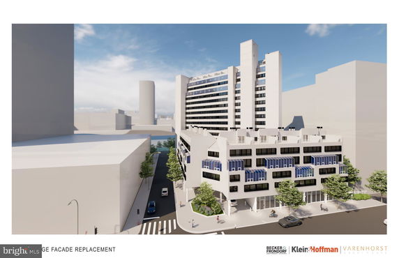 Front view of a multi-story building with modern design elements and large windows.