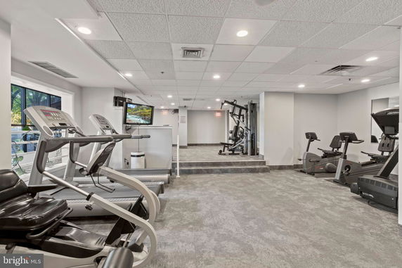 Indoor gym area with various exercise equipment.