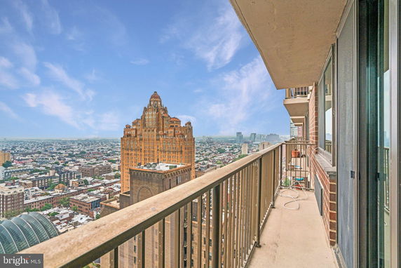 Panoramic view of cityscape from a high-rise balcony