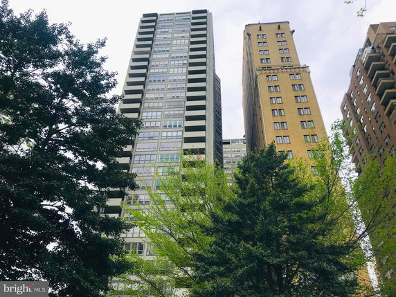 Front view of two tall residential buildings with balconies and windows.