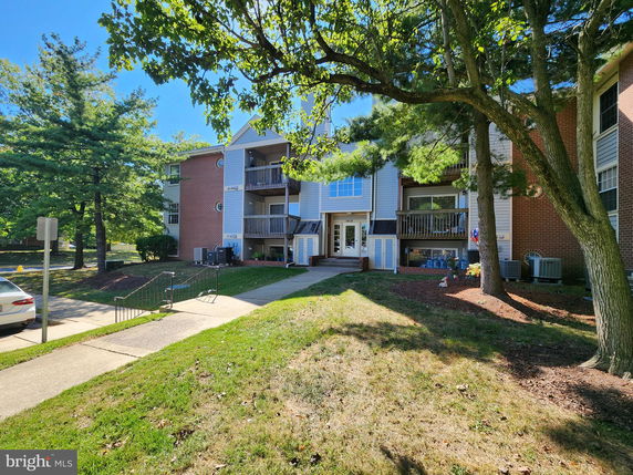 Front view of a multi-story residential building with balconies.