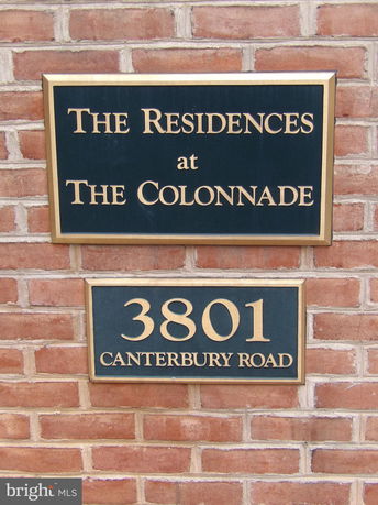 Signage of The Residences at The Colonnade on a brick wall.