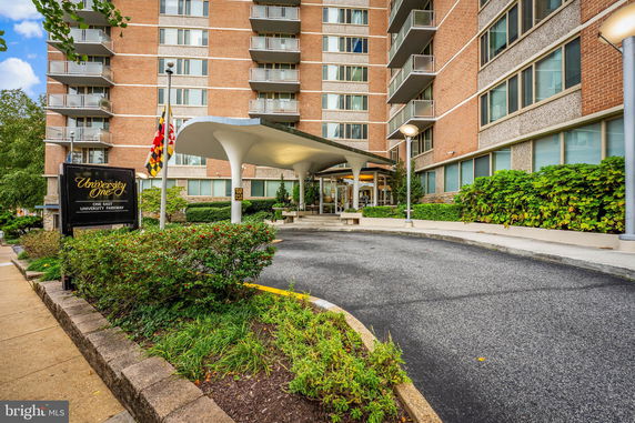 Front view of a multi-story building with a covered entrance.