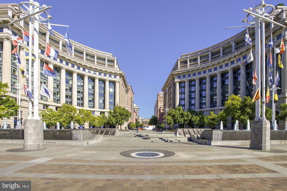 Front view of two symmetric multi-story buildings with columns and large windows.