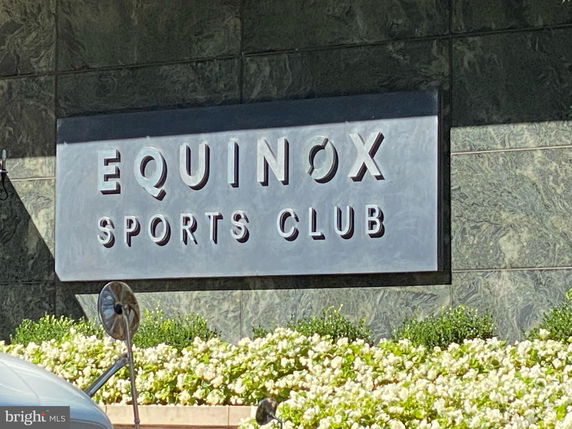 Front view of a sports club with signage reading 'Equinox Sports Club'.