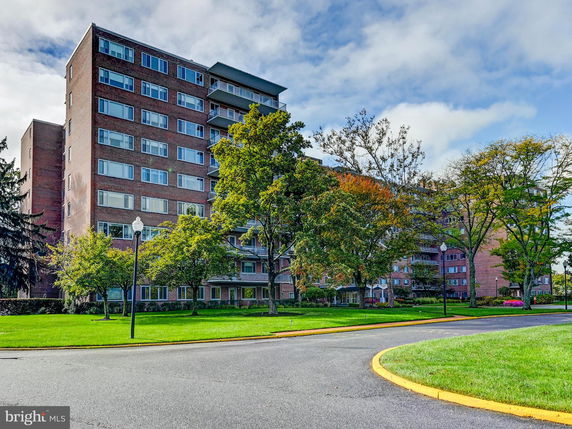 Front view of a multi-story residential building with brick facade.