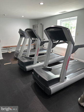 Indoor gym area with treadmills and a window.