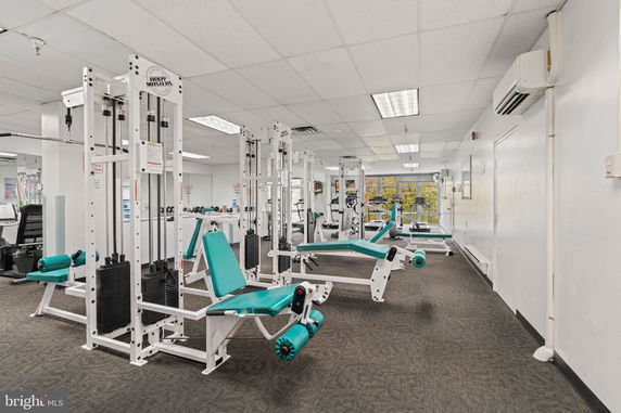 Interior view of a gym with exercise equipment and machines.