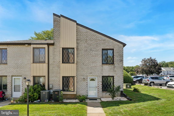 Front view of a townhouse with two stories and brick exterior.