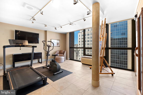 Room with exercise equipment and large windows.