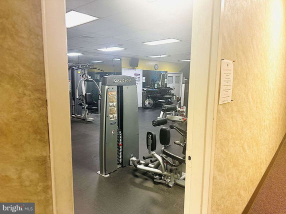 Indoor gym area with exercise equipment.