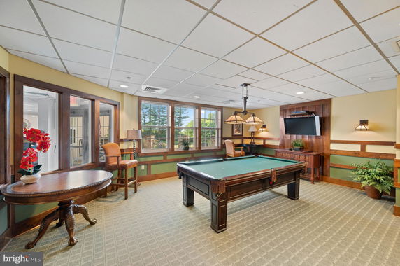 Interior view of a room with a pool table and television.