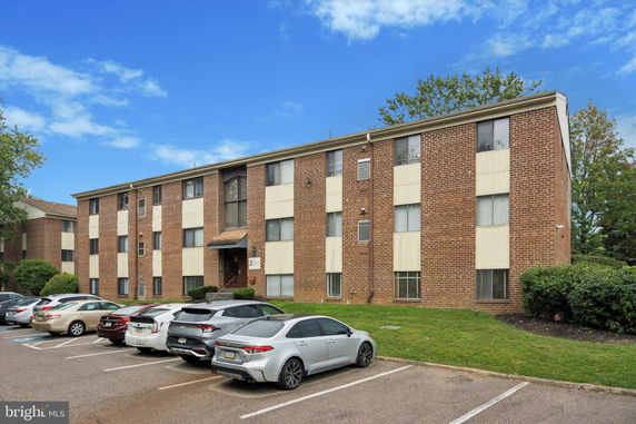 Front view of a three-story brick apartment building.