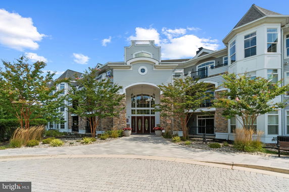 Front view of a multi-story building with a grand entrance and architectural details.