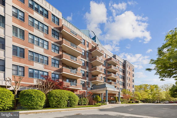 Front view of a multi-story residential building with balconies.