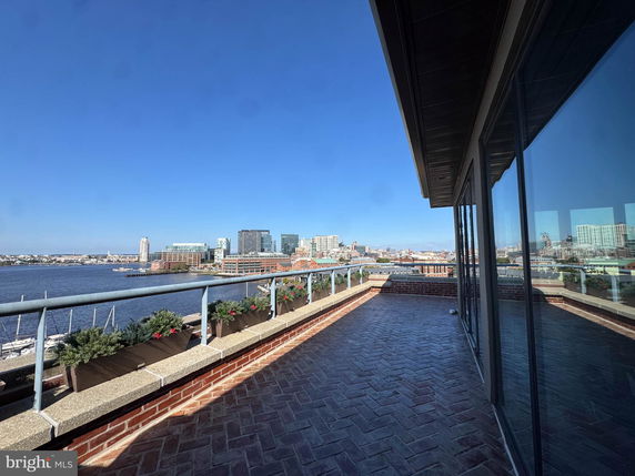 Panoramic view of city skyline and waterfront from a rooftop.