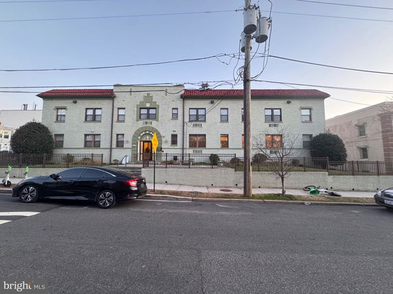 Front view of a two-story building with a central entrance and multiple windows.