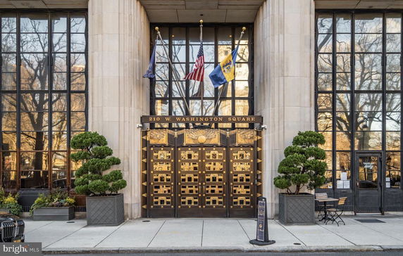 Front view of a building with large glass windows and ornate entrance.