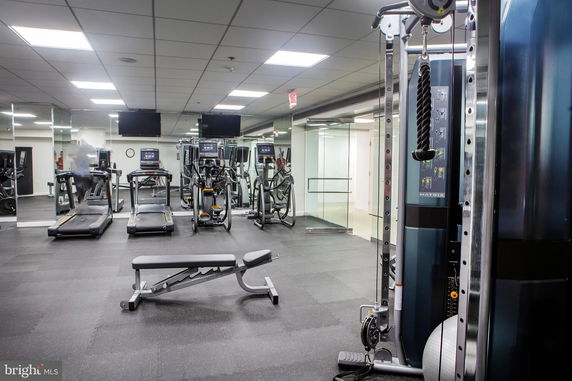 Indoor gym area with exercise equipment including treadmills and elliptical machines.
