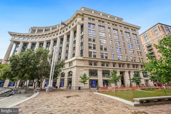 Front view of a large multi-story building with columns.