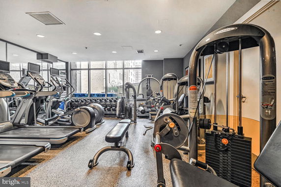 Interior view of a gym with various exercise machines and equipment.