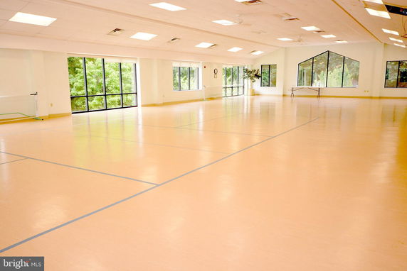 Indoor recreational space with large windows and ample flooring.