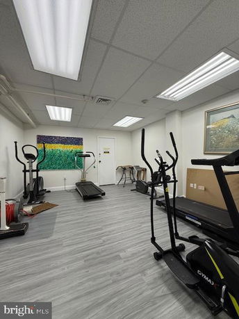 Room with exercise equipment and artwork on the wall.
