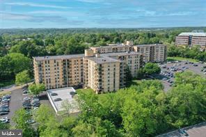 Front view of a multi-story apartment building with parking areas.