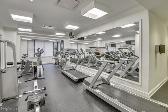 Indoor gym area with exercise equipment including treadmills and stationary bikes.