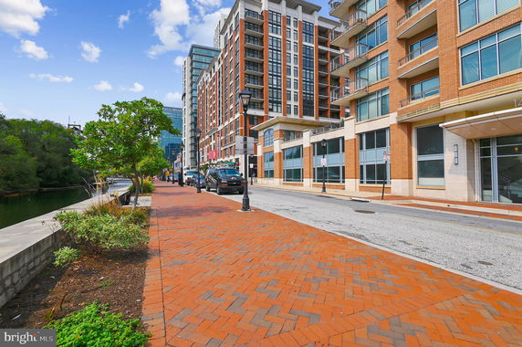 Front view of a multi-story apartment building with large windows and balconies.