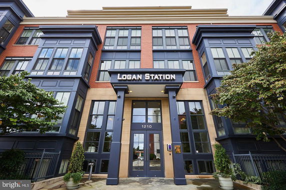 Front view of a multi-story building named Logan Station with large windows and a central entrance.