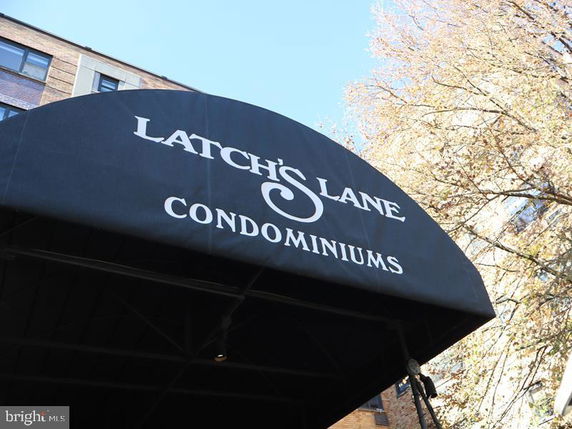 Front view of a condominium entrance with an awning.