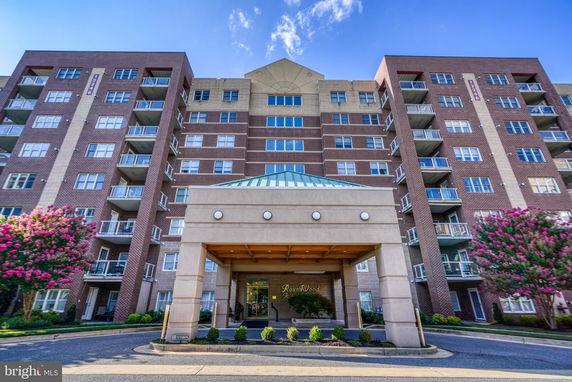 Front view of a multi-story apartment building with balconies.