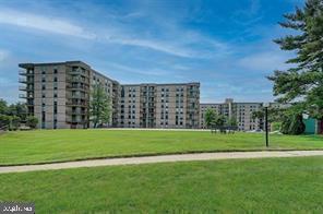 Front view of a multi-story apartment building with balconies.