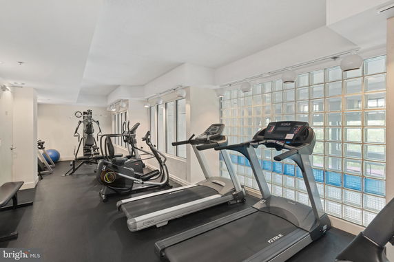 Indoor gym with various exercise equipment including treadmills and ellipticals.