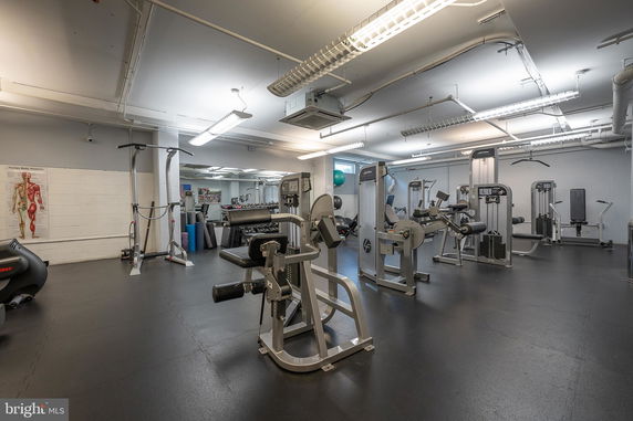 Indoor gym area with various exercise machines.